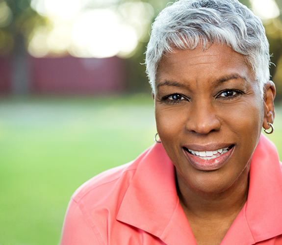 Senior woman in pink blouse smiling