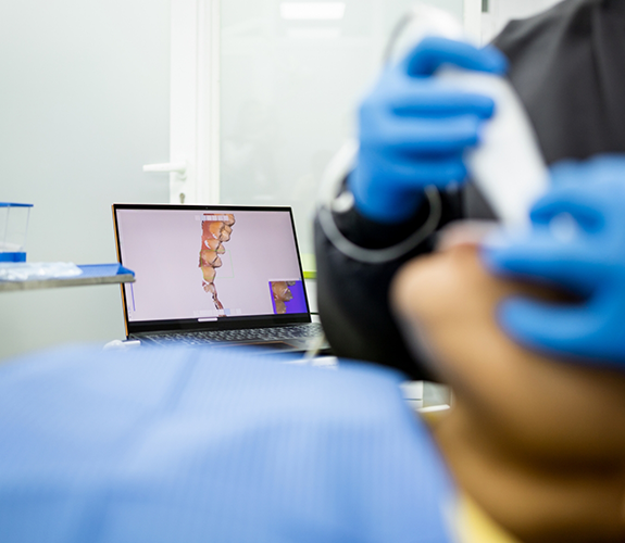 Dental patient having their dentist digitally scan their teeth