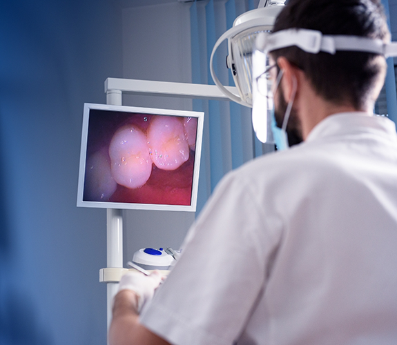 Dentist using intraoral camera to capture photos of a patients teeth in real time