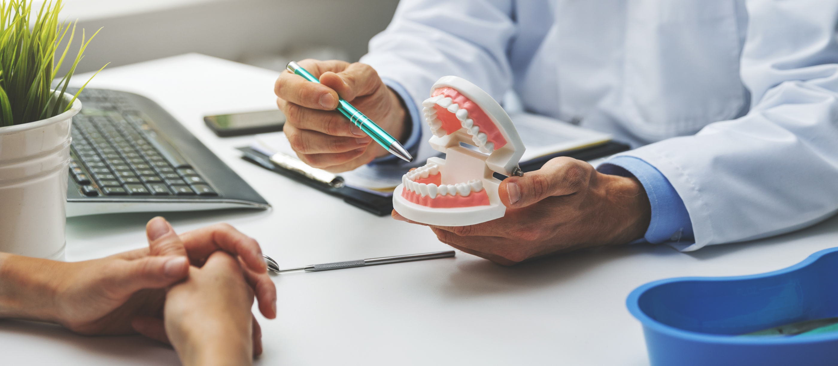 Dentist showing a patient a set of dentures in Boynton Beach