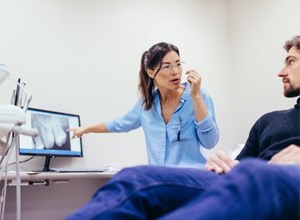 Dentist reviewing X-ray with patient