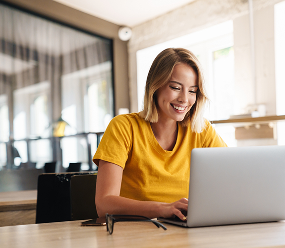 Woman smiling while using her laptop