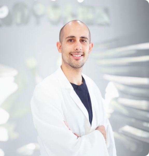Boynton Beach dentist Doctor Camilo Rodriguez smiling in a white lab coat