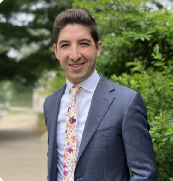 Boynton Beach dentist Doctor Camilo Rodriguez smiling in a white lab coat
