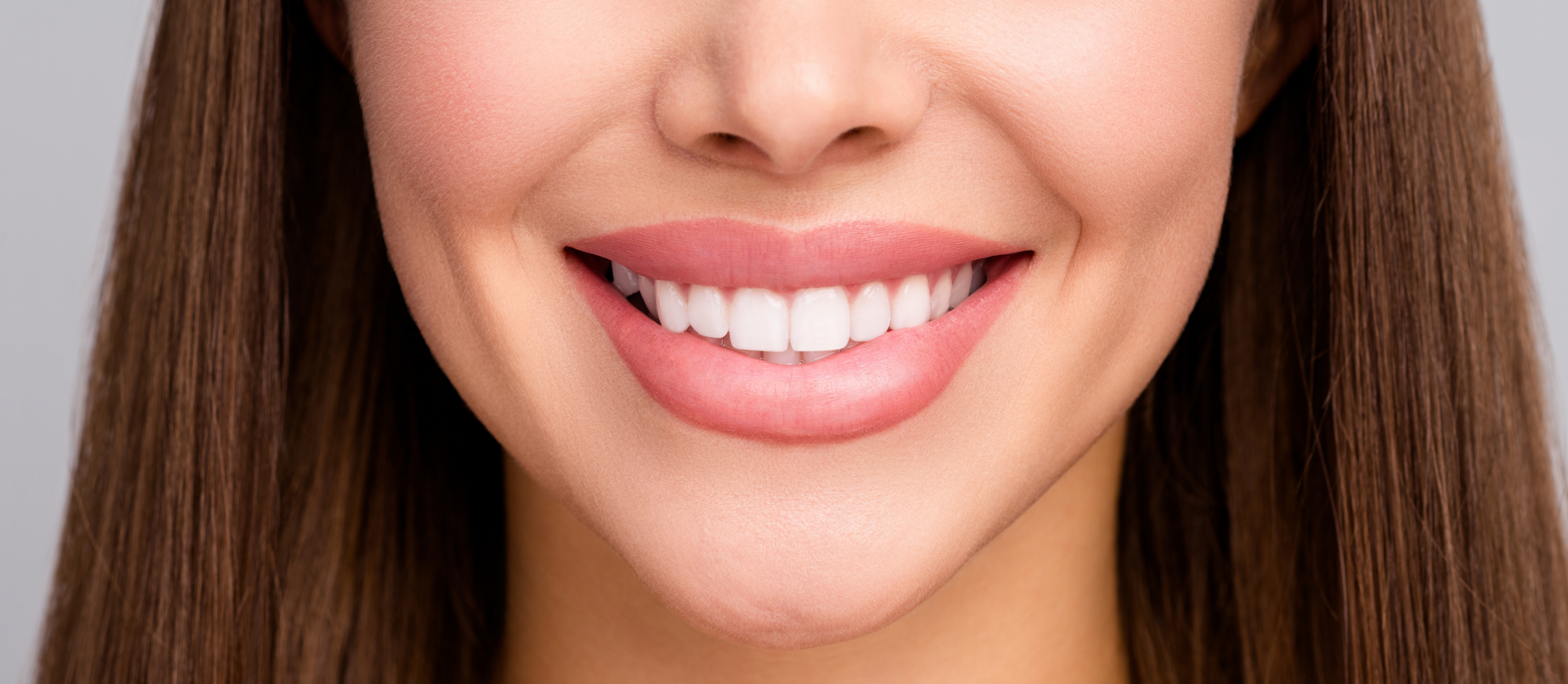 Woman smiling with straight teeth after Invisalign in Boynton Beach