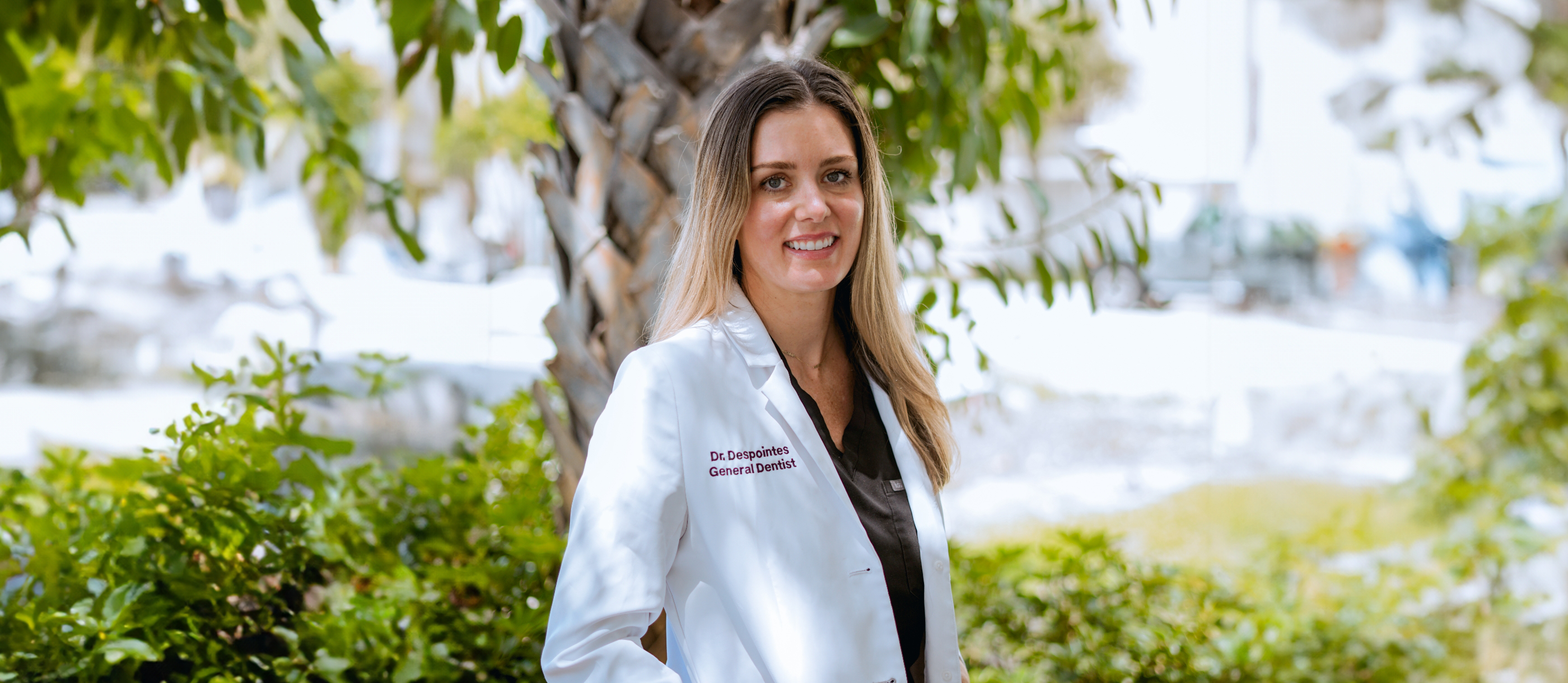 Boynton Beach dentist Doctor D smiling in white lab coat