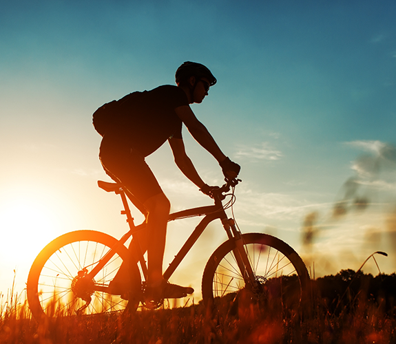 Person riding their bike at sunset