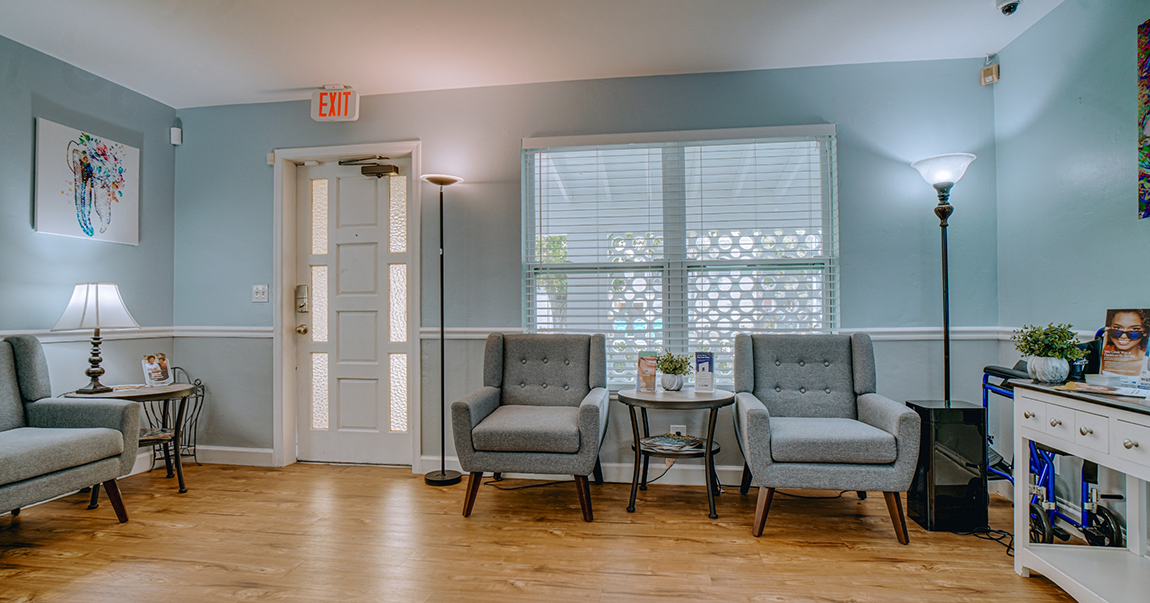 Waiting area with gray armchairs and pale blue walls