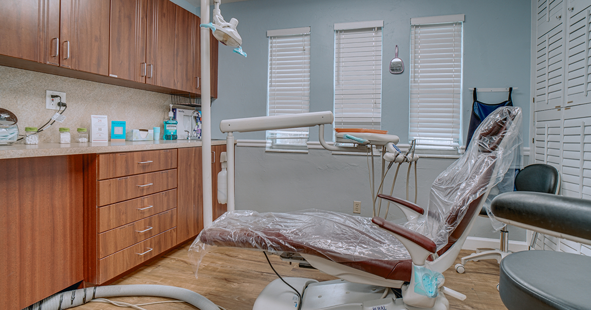 Dental treatment chair covered in plastic wrap