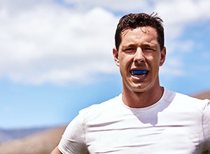 Man wears athletic mouthguard