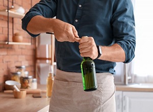 Man opens bottle with opener