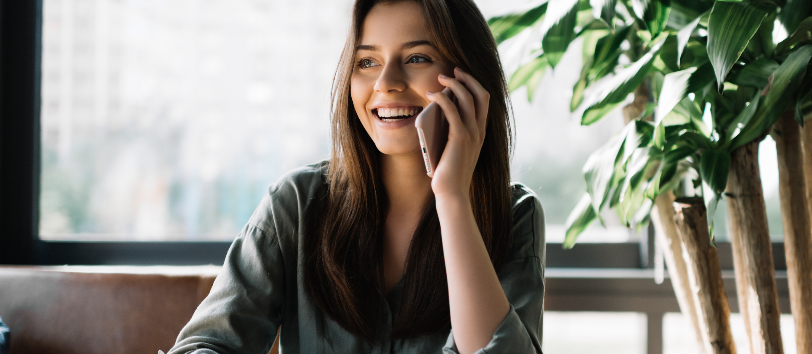 Young woman talking on the phone to request a dental appointment in Boynton Beach