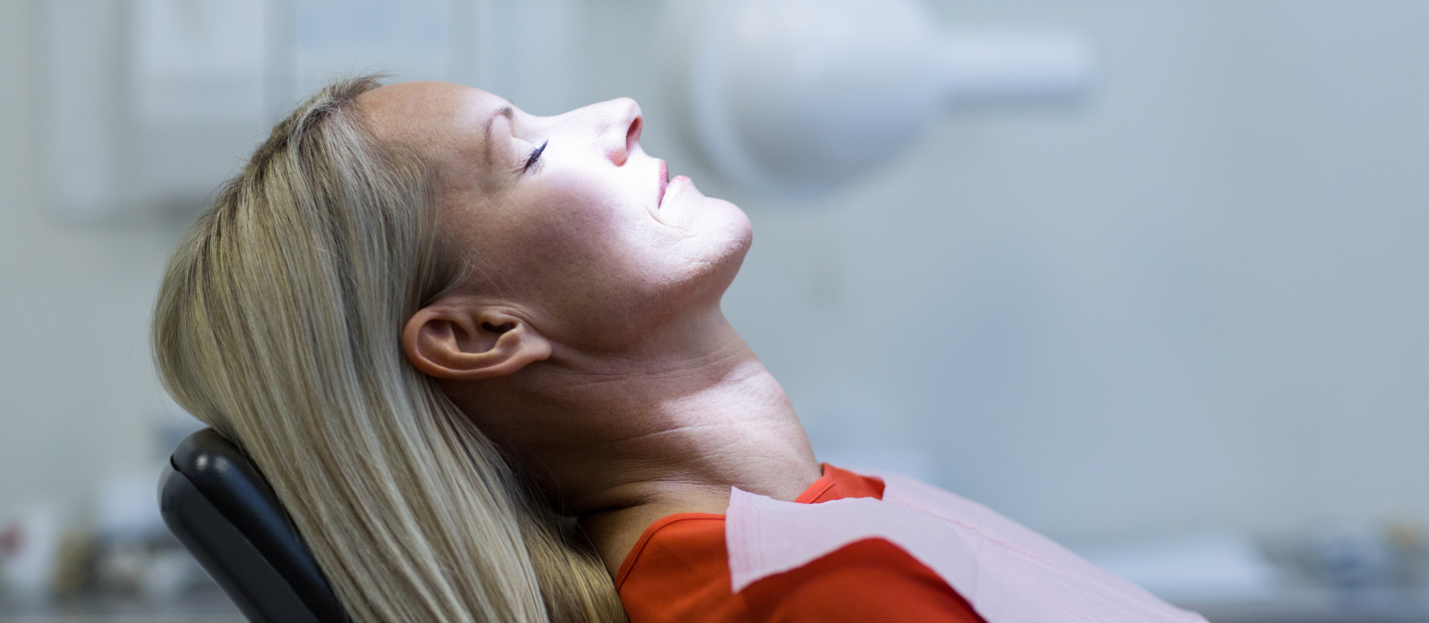 Woman relaxing in dental chair thanks to sedation dentistry in Boynton Beach